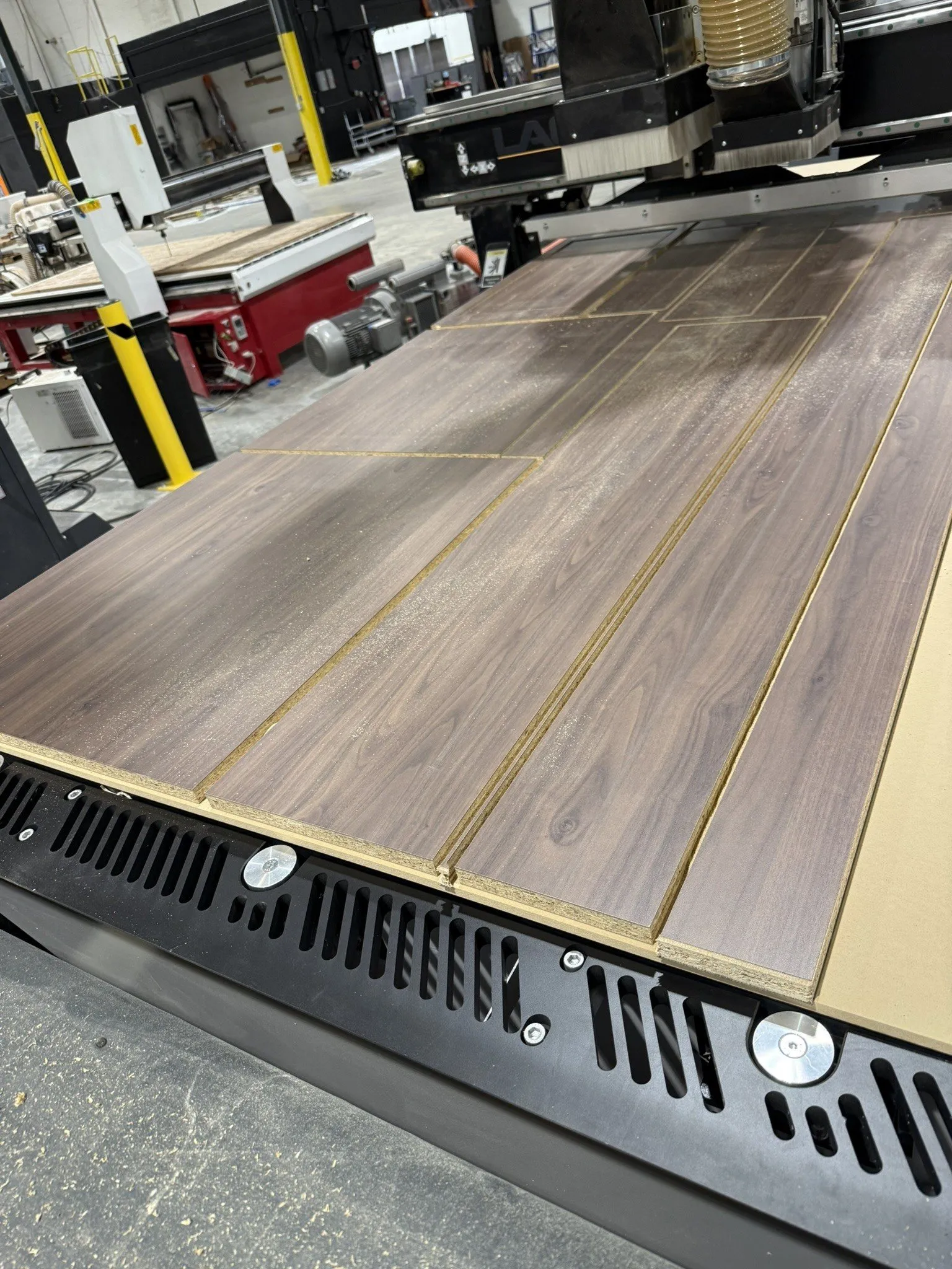 Walnut laminate sheet nested on the CNC